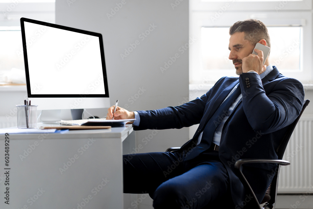 Aufkleber happy man entrepreneur having conversation on cellphone, sitting in front of computer with blank scr