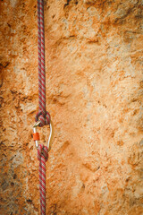 carabiner with climbing rope on rocky background. Climbing concept
