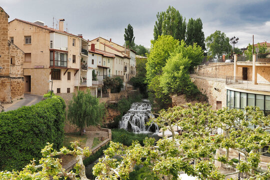 waterfall of the cifuentes river as it passes through the town of trillo