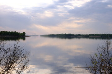 Fototapeta premium View of the Dnieper River from the shore, foggy haze over the water, sunset time