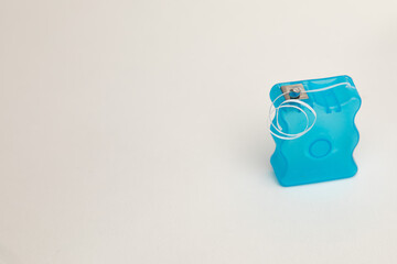 Photo of dental floss. There is copy space to the left. 