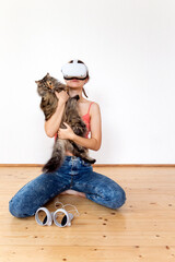 A teenage girl in vr playing online at home with cat