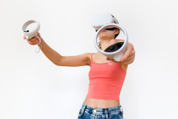 A portrait of a girl in vr glasses with controllers in hands