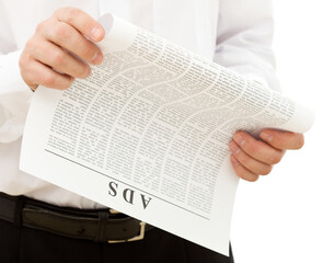 Naklejka premium Man reading ads from the paper - isolated, closeup