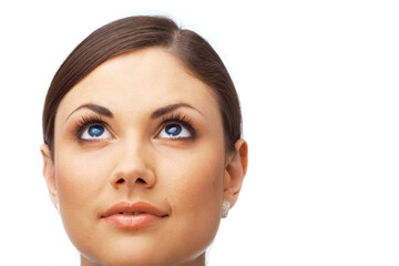 Closeup of a thoughtful young woman looking up over white background