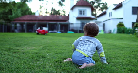 Fototapeta premium Beautiful baby child crawling outdoors on grass