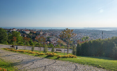Fototapeta na wymiar Panoramic view from the city park with flowers and a path to Istanbul on a summer day in a sunny haze. Turkey