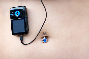 sexy pierced belly with hanging mp3 player