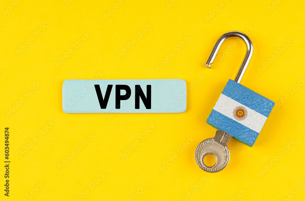 Poster on the yellow surface is an open lock with a key and a sticker with the inscription - vpn