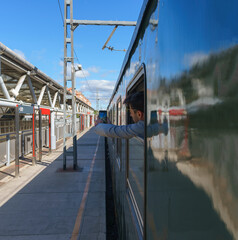 Young man takes photo from train window