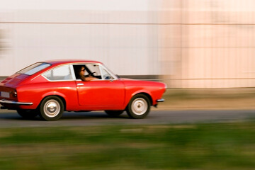 Fototapeta na wymiar Red Car moving fast