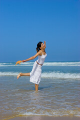Fototapeta premium Beautiful woman feeling the breeze with a starfish on the hand