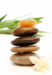 Fototapeta premium Balancing stones with leaves and white background