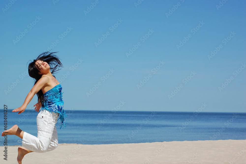 Poster active woman jumping on the beach