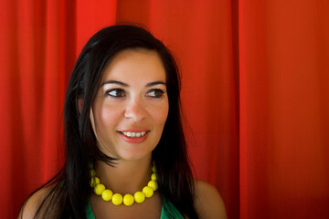 Young and beautiful woman smiling on a red background