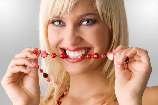 cute blond girl with glamor make up with red necklace