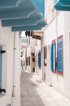 street in the old town of mandraki nisyros island greece country kos santorini travel sightseeing wandering vertical wallpaper white houses with blue shutters