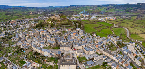 Aerial view around the old town of the city Sévérac-d'Aveyron in France on a sunny day in early spring	
