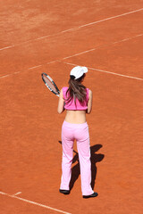 Girl playing tennis outdoor on court