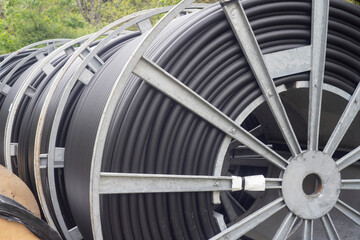 big roll of black power cable on construction site