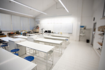 empty school classroom with white desks