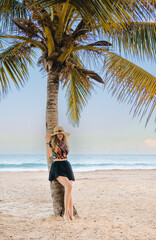 young girl with hat on the beach