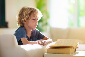 Fototapeta na wymiar Child reading a book. Boy doing homework.