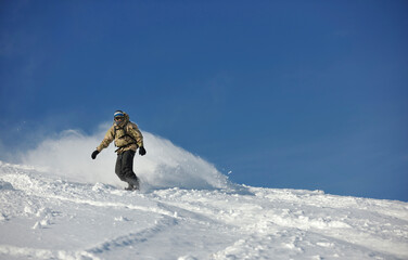 freestyle snowboarder jump and ride free style  at sunny winter day on mountain