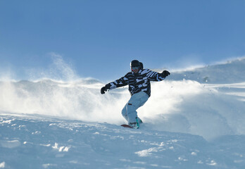 Naklejka na ściany i meble freestyle snowboarder jump and ride free style at sunny winter day on mountain