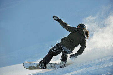 freestyle snowboarder jump and ride free style  at sunny winter day on mountain