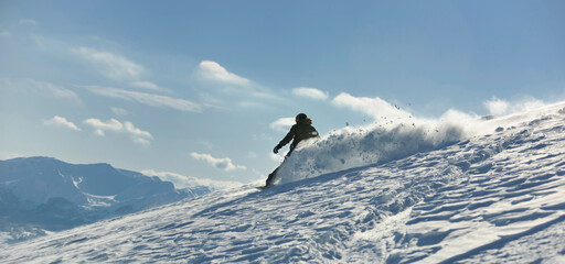 freestyle snowboarder jump and ride free style  at sunny winter day on mountain