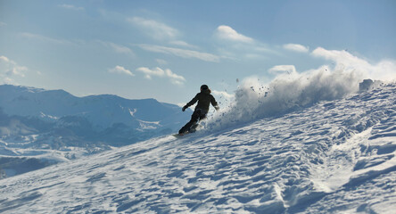 freestyle snowboarder jump and ride free style  at sunny winter day on mountain