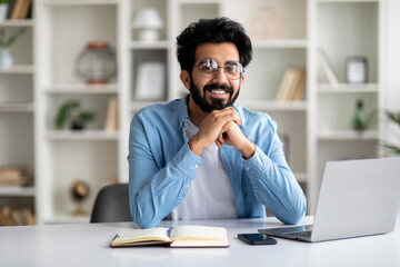 Modern Freelancer. Happy Millennial Indian Man Sitting At Desk With Laptop