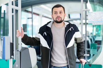 Portrait of male passenger in tram car on a spring day