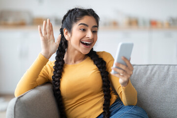 Portrait Of Happy Indian Woman Making Video Call Via Smartphone At Home