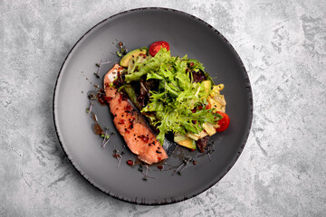 Roasted salmon fillet withvegetables and mixed greens