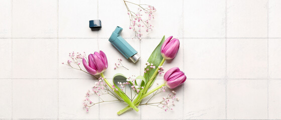 Fototapeta na wymiar Asthma inhaler with flowers on light background, top view