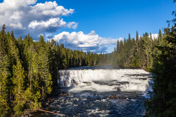 Wide-fronted waterfall, large, frothing cascade into the Murtle River amid spruce forests. Helmcken...