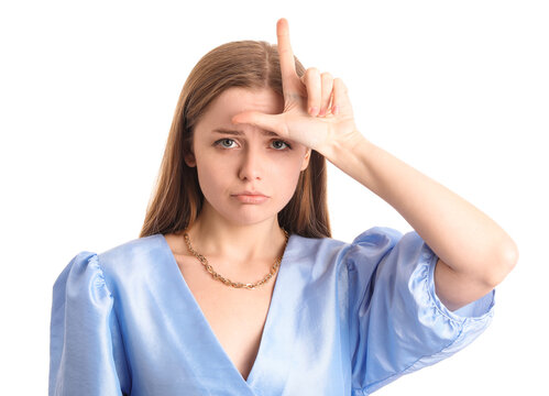 Sad young woman in dress showing loser gesture on white background, closeup