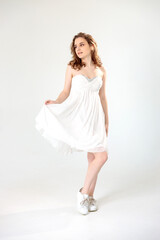young girl in a white dress on a white background