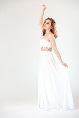 Fototapeta na wymiar young girl in a white dress on a white background