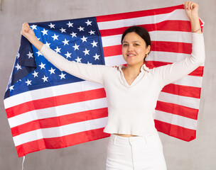 Portrait of positive young woman with the flag of USA