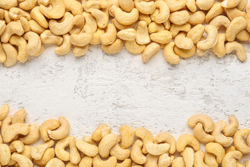 frame made of cashew nuts on light background