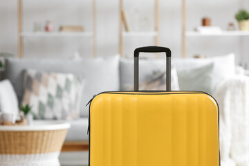 Yellow suitcase in living room, closeup
