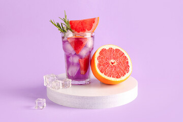 Purple gin and tonic with grapefruit on lilac background