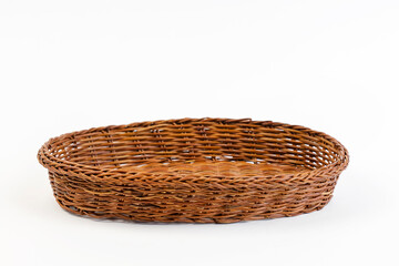 Close up of an empty wicker basket on a white background.