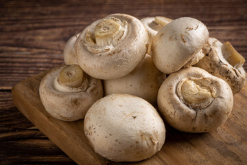 Fresh white mushrooms on the table.