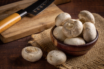 Fresh white mushrooms on the table.