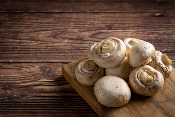 Fresh white mushrooms on the table.