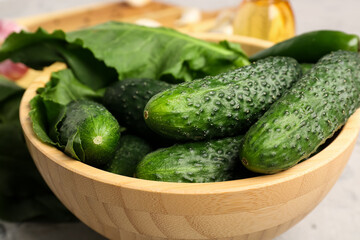 Bowl with fresh cucumbers for preservation on table, closeup